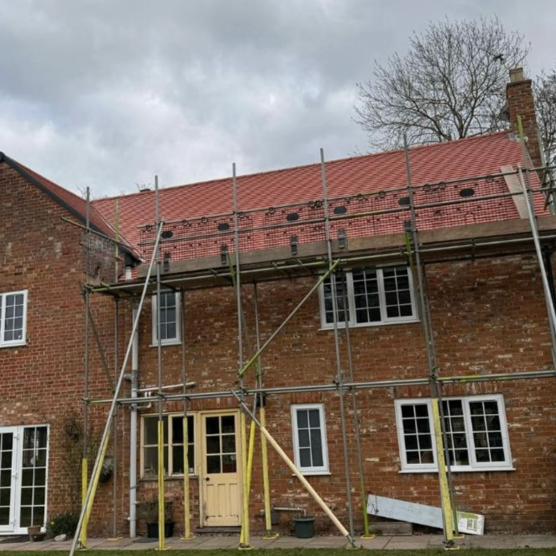 Large re-roof project shown with scaffold access